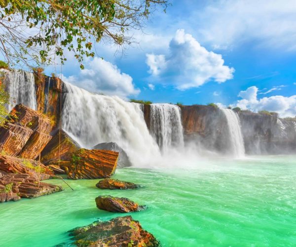 Dray Nur Waterfall in Vietnam's Central Highlands, surrounded by lush nature.